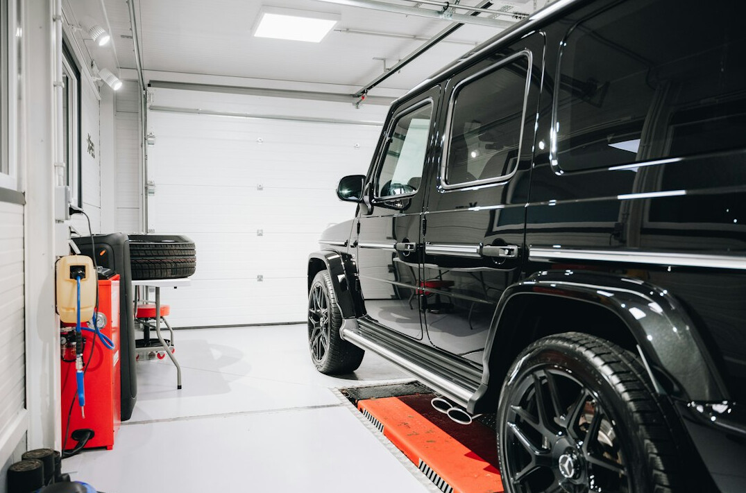 Workshop with a car on a lift and tools on the wall