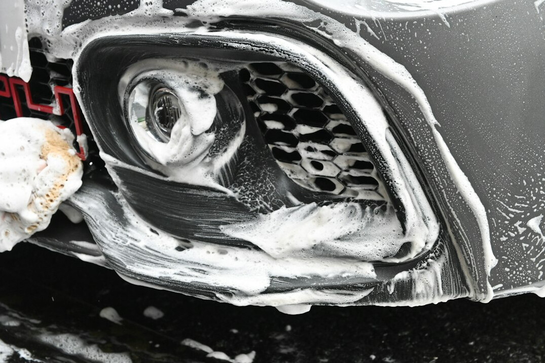 Close-up of a car headlight and fender with clean paint